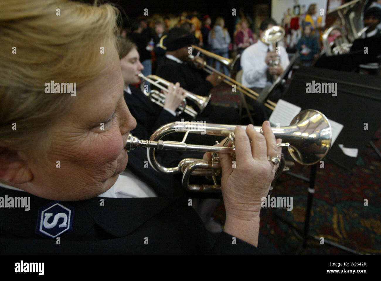 Salvation Army band member Linda Cooper plays her trumpet during the Wehrenberg Cans Film Festival at the Des Peres 14 Cine in Des Peres, Mo on December 3, 2005. Movie goers exchange canned goods for a movie ticket with the food going to feed the needy served by the St. Louis area Salvation Army. Last year the Wehrenberg Cans Film Festival yeilded 254 thousand cans in six hours. (UPI Photo/Bill Greenblatt) Stock Photo
