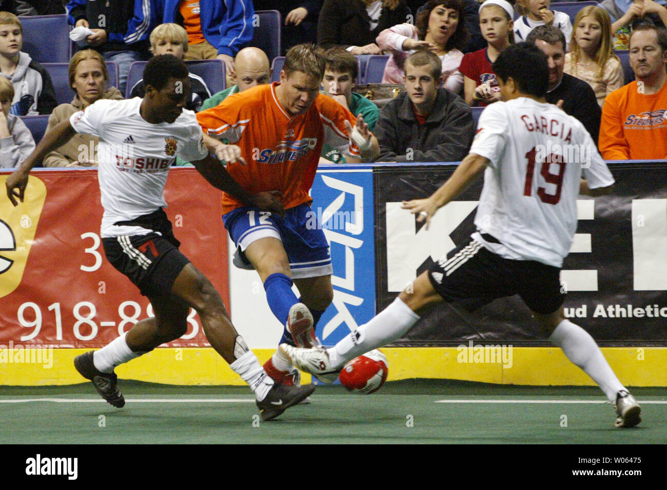 Baltimore Blast's Carlos Garcia  (R) and Joel Bailey (L) battle St. Louis Steamers Randy Sonderman for possession of the ball during the first quarter of their MISL game at the Savvis Center in St. Louis on December 16, 2005. (UPI Photo/Bill Greenblatt) Stock Photo