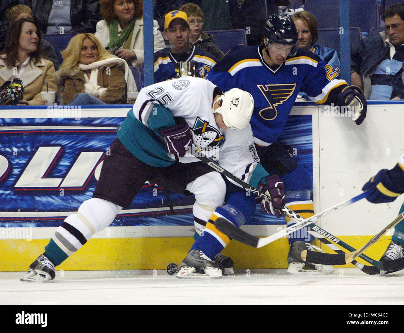 St. Louis Blues Petr Cajanek (R) fights Anaheim Mighty Ducks Zenon Konopka for the puck against the boards in the first period at the Savvis Center in St. Louis on December 31, 2005. (UPI Photo/Bill Greenblatt) Stock Photo