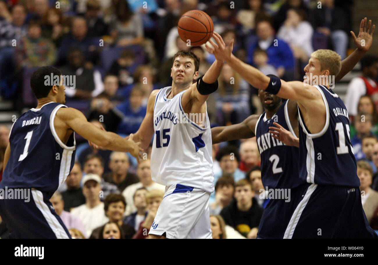 Saint Louis University Billikens Ian Vouyoukas (15) tries get his fingers on the basketball while Xavier Musketeers (L to R) Josh Duncan (1) Brian Thornton (2) and Justin Doellman also try to take control in the second half at the Savvis Center in St. Louis on February 5, 2006. (UPI Photo/Bill Greenblatt) Stock Photo