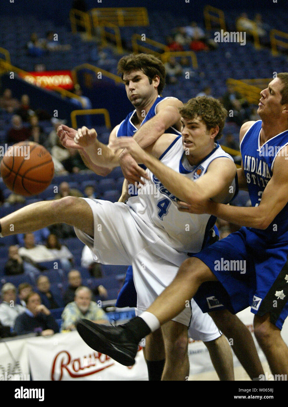 Drake Bulldogs Brent Heemskerk (4) battles Indiana State Sycamores Trent  Wurtz (L) and Adam Arnold (R) for the loose basketball during the first  half of the Missouri Valley Tournament at the Savvis