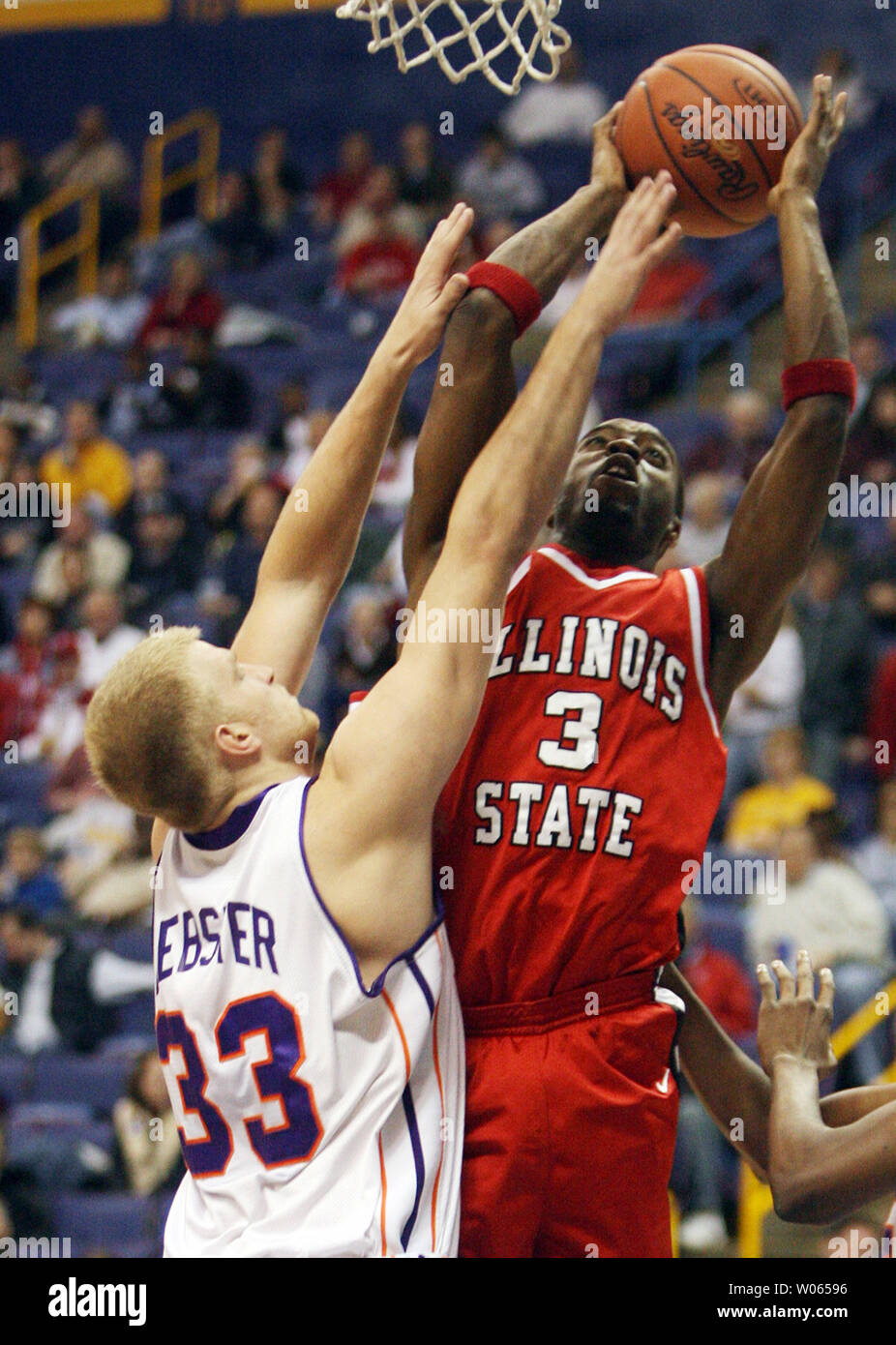 Evansville Purple Aces' Matt Webster (33) tries to defend as Illinois State  Redbirds Nedu Onyeuku shoots for two points during the first half of the  Missouri Valley Tournament at the Savvis Center