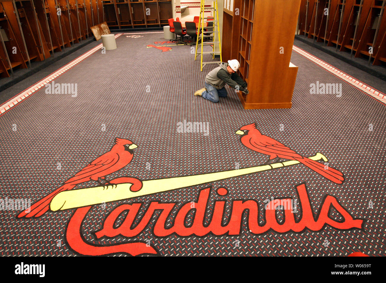 Construction worker Keith Stewart tucks in wires in the St. Louis Cardinals  locker room at the new Busch Stadium on March 3, 2006. Work continues on a  24-hour basis as preperations are