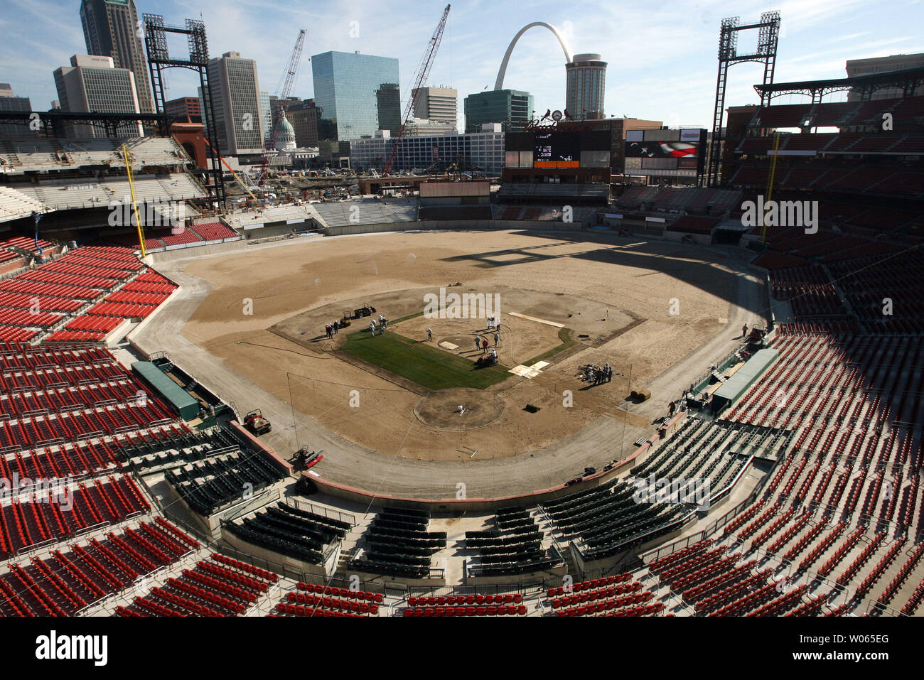 Grounds crew members lay sod grass on the infield of the new Busch Stadium in St. Louis on March 15, 2006. Nearly 20 truckloads of sod from Fort Morgan, CO will cover the Busch Stadium playing surface, about 100 thousand square feet. The Cardinals will play their first game in the new facility on April 10. (UPI Photo/Bill Greenblatt) Stock Photo