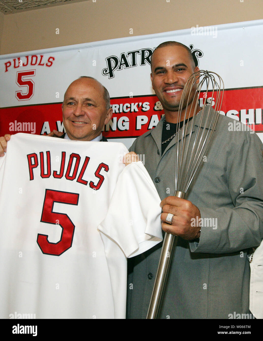 St. Louis Cardinals Albert Pujols (R) along with  Hanon Management Group's Patrick Hanon, pose for a photograph with a wisk after announcing the partnership of a group that will open a resturant in the fall called PUJOLS FIVE, in the Westport area of St. Louis on June 1, 2006. The Pujols' hope that the resturant will help fund the Pujols Family Foundation, the couples 501C3 organization. (UPI Photo/Bill Greenblatt) Stock Photo