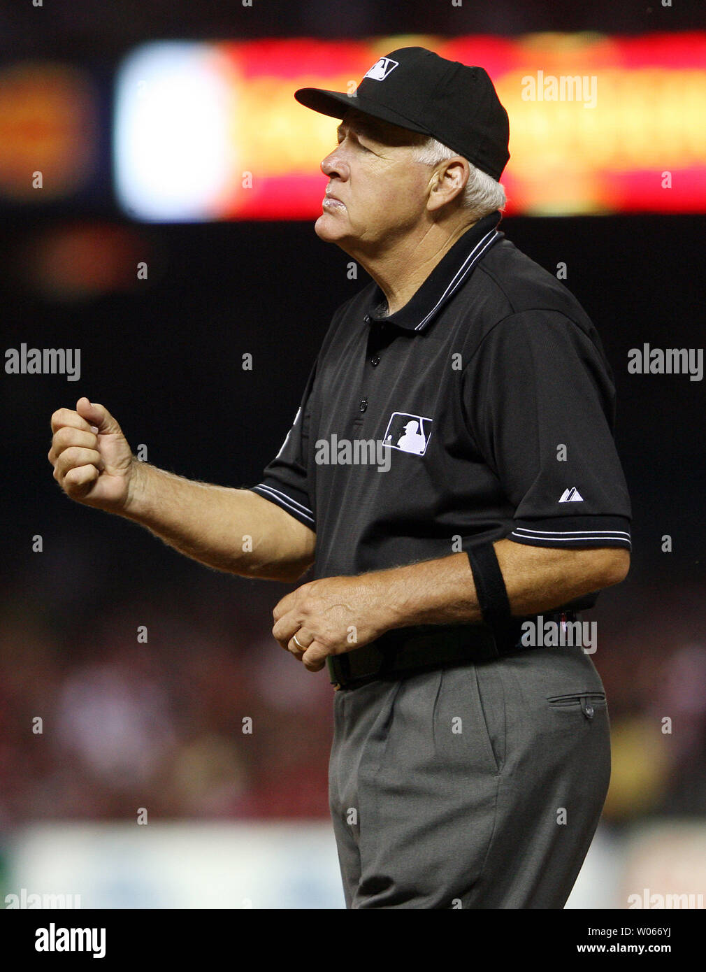 First base umpire Joe Brinkman makes the call on a runner thrown out during a game between the  Cincinnati Reds and the St. Louis Cardinals at Busch Stadium in St. Louis on June 6, 2006. The umpire crew is wearing black armbands as they remember former umpire Eric Gregg who died yesterday at the age of 55 in Philadelphia after a stroke.(UPI Photo/Bill Greenblatt) Stock Photo