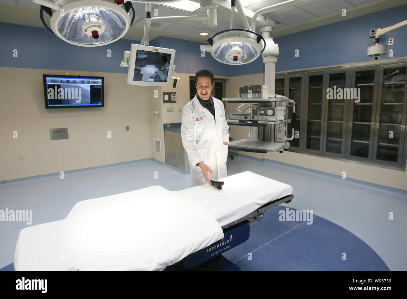 Dr. Edward Savage, Medical Director of Heart and Vascular Services at St. John's Mercy Heart Hospital, checks out a remote control device in one of the new five state-of-the-art operating rooms during the grand opening in Creve Coeur, Mo on June 22, 2006. The new $140 million heart hospital project makes it one of the most advanced hospitals of its kind.   (UPI Photo/Bill Greenblatt) Stock Photo