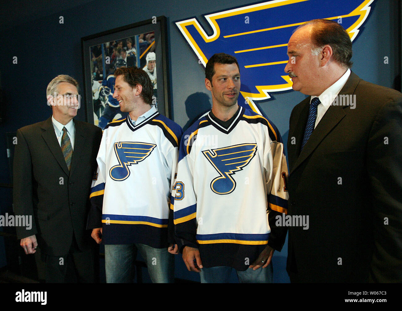 New St. Louis Blues President John Davidson (R) chats with newly signed free agent right winger Bill Guerin While team general manager Larry Pleau (L) talks with defenseman Jay McKee, following a press conference at the Savvis Center in St. Louis on July 6, 2006. McKee comes to St. Louis from Buffalo where he played 10 seasons and Guerin from Dallas. Guerin also spent seven seasons in New Jersey, four in Edmonton and two in Boston. (UPI Photo/Bill Greenblatt) Stock Photo