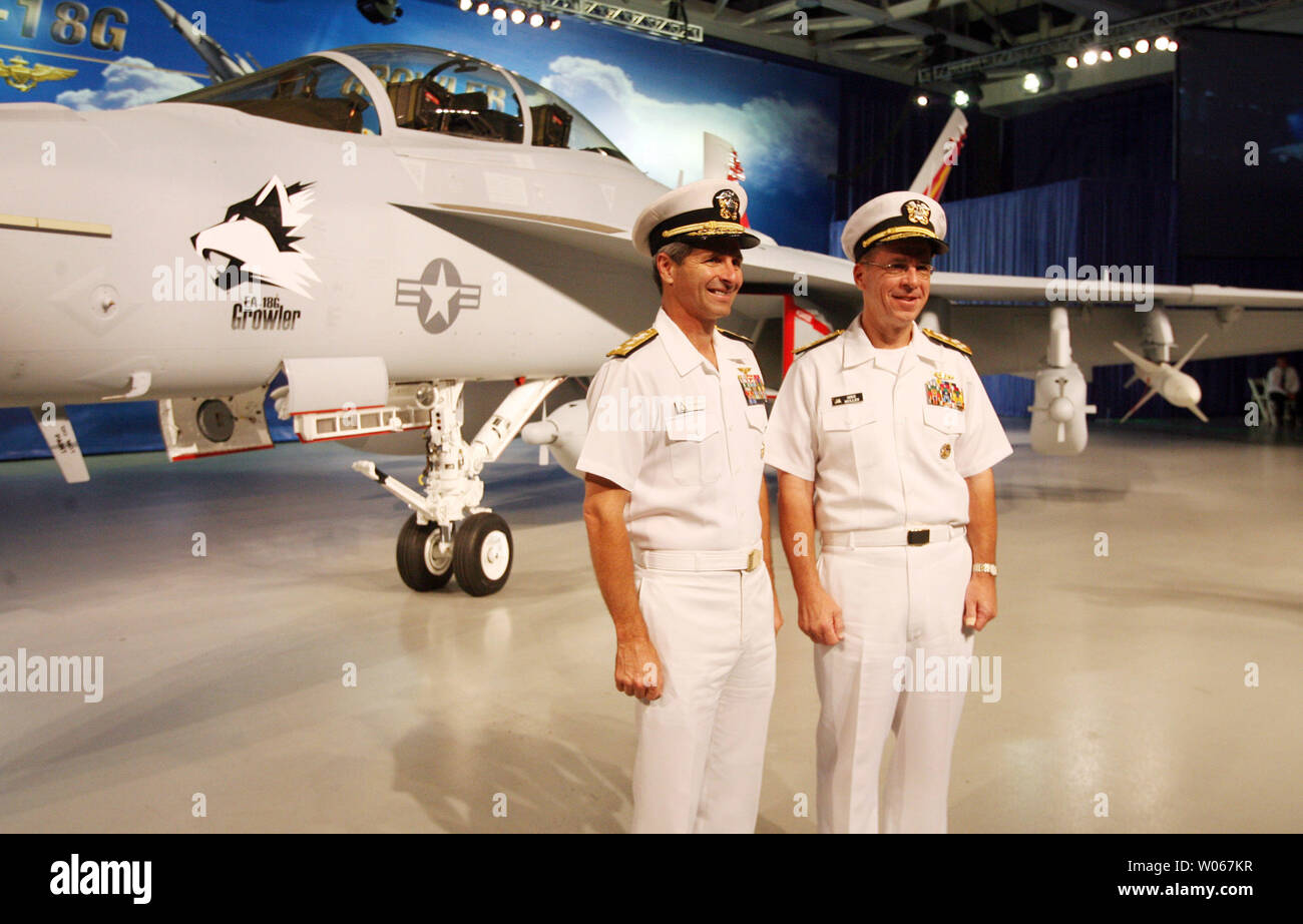Admiral Michael Mullen, Chief of Naval Operations for the United States Navy (R) and Rear Admiral David Venlet, Program Executive Officer, Tatical Air Programs Naval Air Systems Command, pose for a photograph in front of the new EA-18G Growler airborne electronic aircraft, during rollout ceremonies at the  Boeing aircraft assembly plant in St. Louis on August 3, 2006. The plane is a two-seat F/A-18F Super Hornet with an advanced weapons, sensors and communications systems. (UPI Photo/Bill Greenblatt) Stock Photo