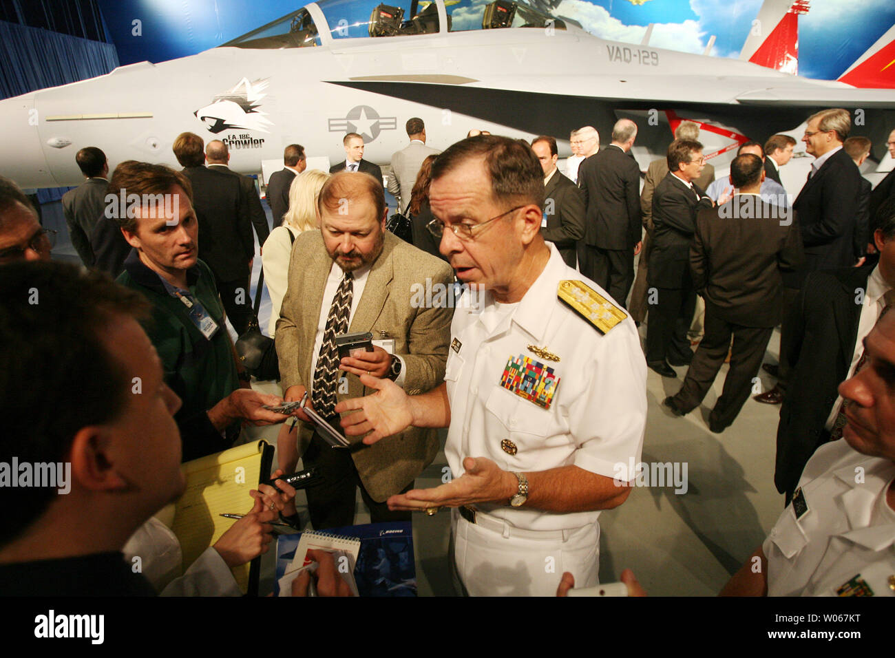 Admiral Michael Mullen, Chief of Naval Operations for the United States Navy, talks with reporters after a rollout of the new EA-18G Growler airborne electronic aircraft, at the  Boeing aircraft assembly plant in St. Louis on August 3, 2006. The plane is a two-seat F/A-18F Super Hornet with an advanced weapons, sensors and communications systems. (UPI Photo/Bill Greenblatt) Stock Photo