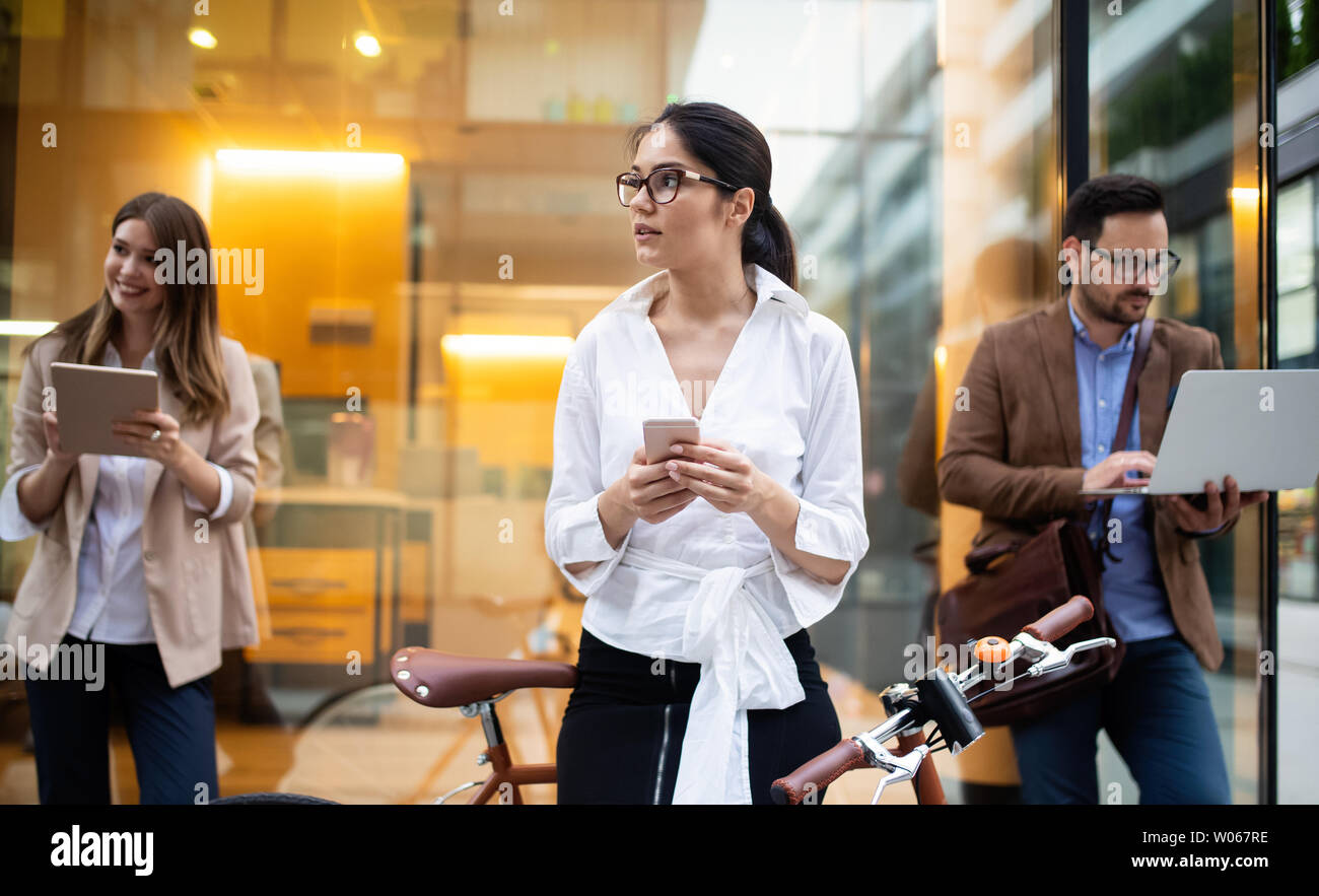 View at young business people talking and smiling outdoors Stock Photo ...