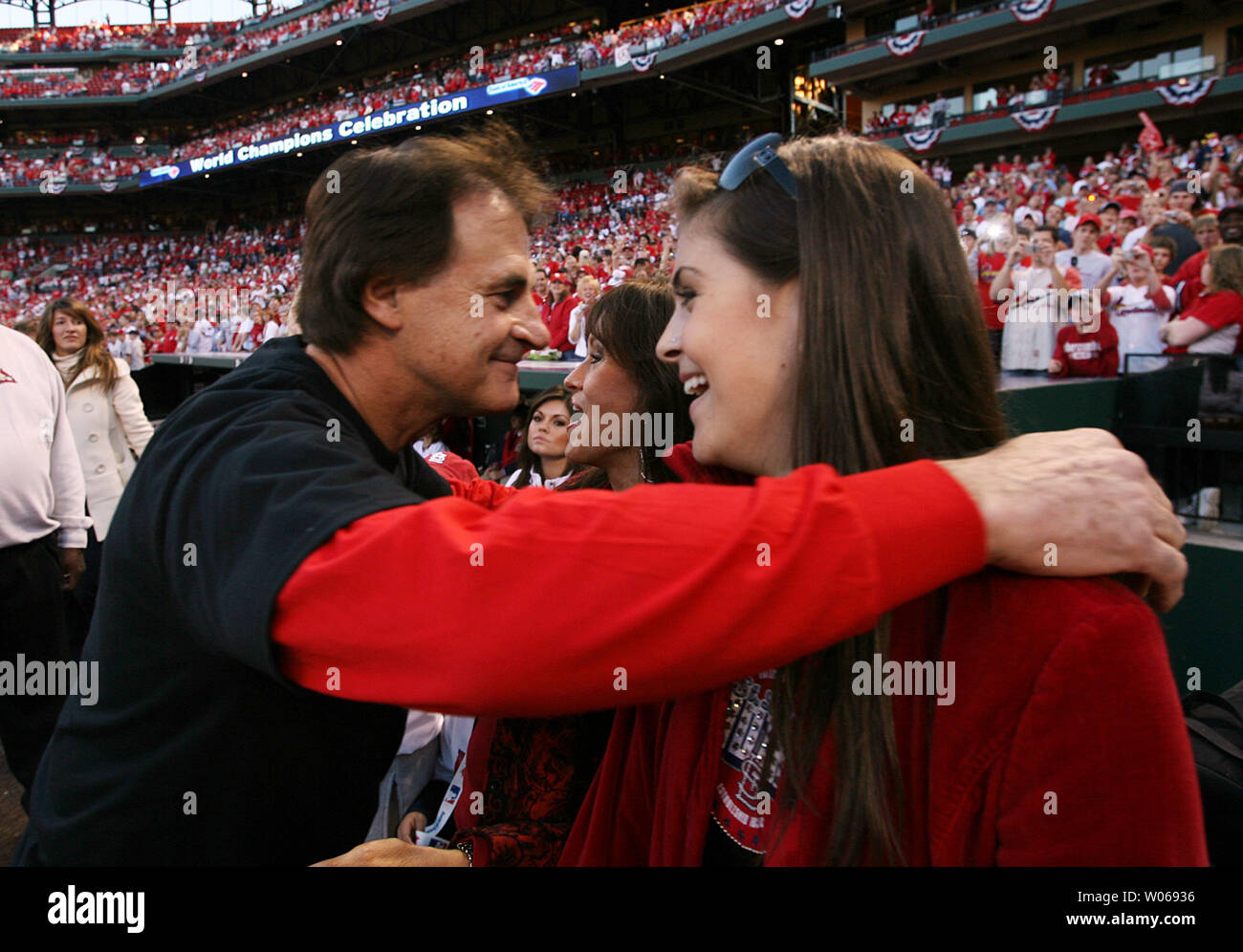 St. Louis Cardinals manager Tony La Russa hugs wife Elaine and daughter  Devon during a celebration ceremony for the new World Champions at Busch  Stadium in St. Louis on October 29, 2006.