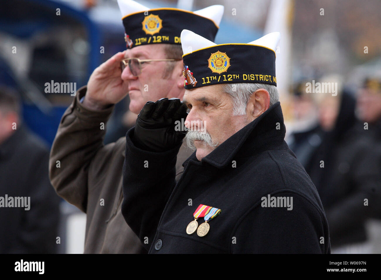 War veterans Dave Beckley (L) and Arnold Miller salute during the singing of the National Anthem at the annual St. Louis Regional Veterans Day Observance and Parade in St. Louis on November 11, 2006. (UPI Photo/Bill Greenblatt) Stock Photo