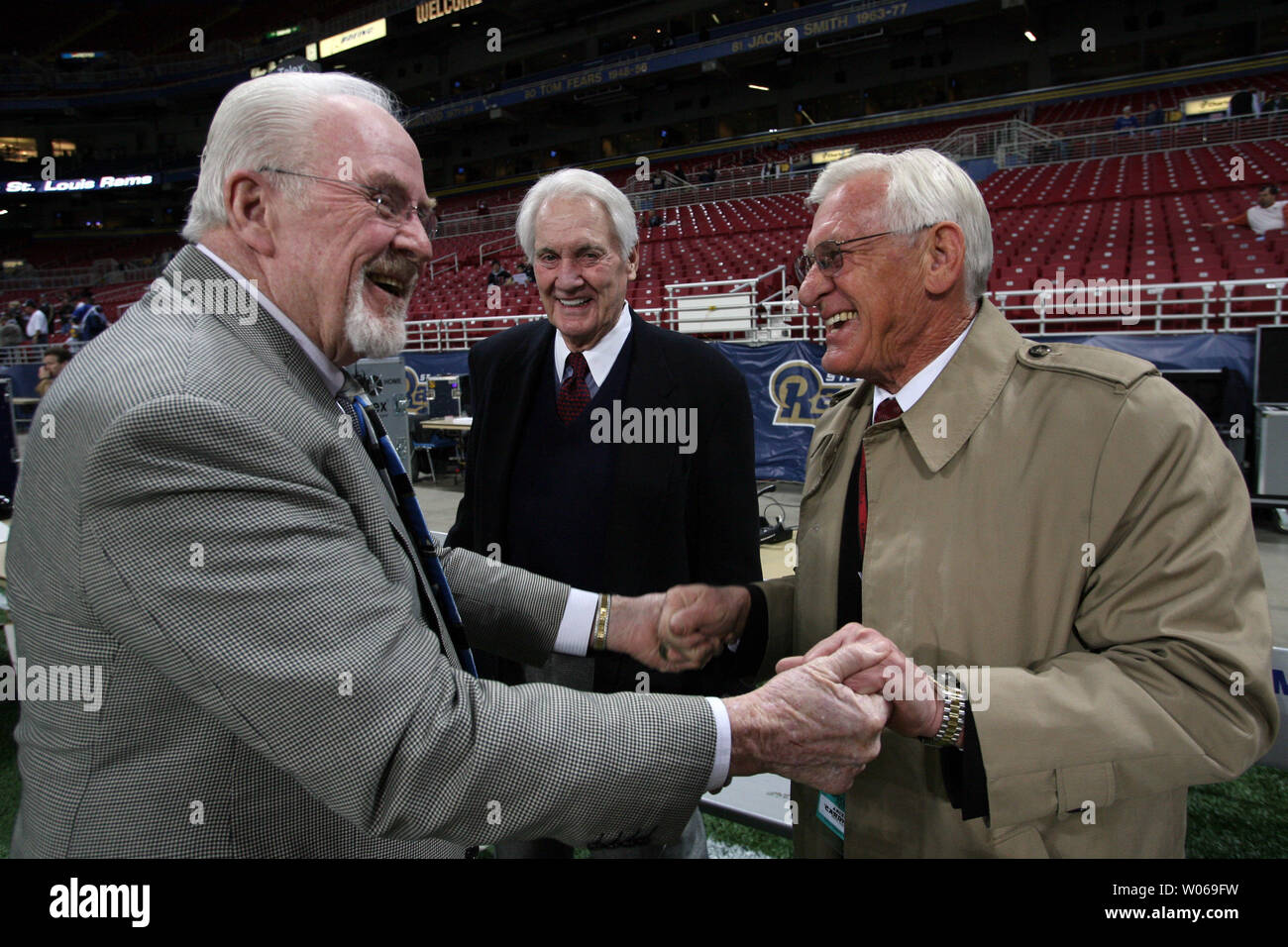Former St. Louis Rams offensive coordinator Jim Hanifan (L) jokes with former Arizona Cardinals general manager Larry Wilson as Fox football announcer Pat Summerall (C) looks on before a game between the Arizona Cardinals and the St. Louis Rams at the Edward Jones Dome in St. Louis on December 3, 2006.  Hanifan was Wilson's coach when the two were members of the old St. Louis Cardinals football team in the 1970's. (UPI Photo/Bill Greenblatt) Stock Photo