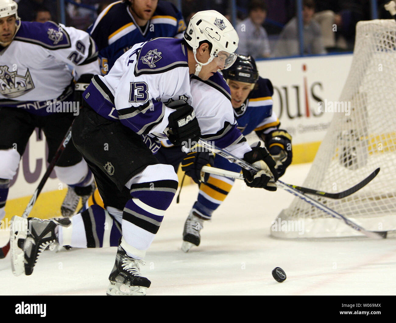 Los Angeles Kings Michael Cammalleri (13) works the puck to the front of the net as St. Louis Blues Ryan Johnson (R) dives to stop him during the first period at the Scottrade Center in St. Louis on December 21, 2006. (UPI Photo/Bill Greenblatt) Stock Photo