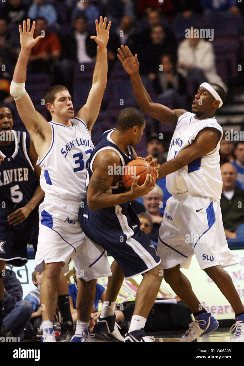 Saint Louis University Billikens Luke Meyer (L) and Danny Brown (R) put the pressure on Xavier Musketeers Justin Cage during the first half at the Scottrade Center in St. Louis on January 13, 2007. (UPI Photo/Bill Greenblatt) Stock Photo