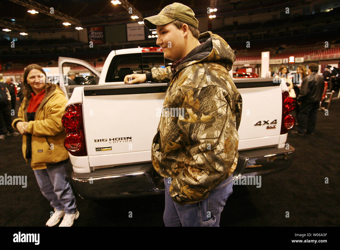 Mitchell Hults, the 15-year-old who identified the get-a-way vehicle used by kidnapper Michael Devlin to kidnap Ben Ownby on January 8, 2007, stands at the rear of the new truck given to him as a reward by Chrysler at the St. Louis Auto Show while mom Sherri Hults looks on in St. Louis on January 24, 2007. Although only 15, Hults will turn 16 in six months and plans to use it to haul his  ATV. (UPI Photo/Bill Greenblatt) Stock Photo