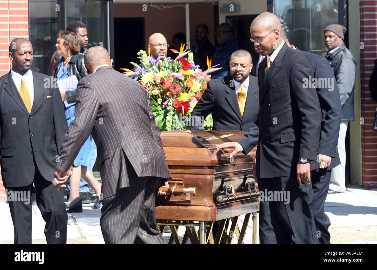 Pallbearers wheel the casket of Denver Broncos running back Damien Nash from the Friendly Temple Missionary Baptist Church to a horsedrawn carriage for the three mile trip to a cemetery in St .Louis on March 5, 2007. Nash, 24, who is from St. Louis, died on February 24, after playing in a charity basketball game. (UPI Photo/Bill Greenblatt) Stock Photo
