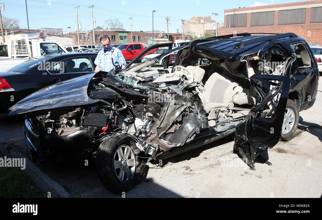 A St. Louis police officer inspects the wreckage of the 2007 Ford Explorer  belonging to St. Louis Cardinals relief pitcher Josh Hancock, who was  killed when the car slammed into the rear