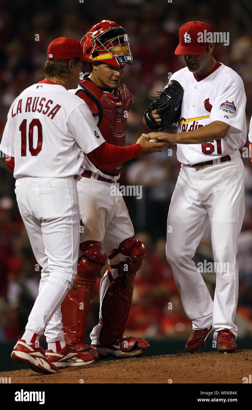 As St. Louis Cardinals catcher Yadier Molina looks on, manager Tony La Russa takes the baseball from pitcher Tyler Johnson after walking in the go-ahead run for the Colorado Rockies in the ninth inning at Busch Stadium in St. Louis on May 7, 2007. Colorado won the game, 3-2.  (UPI Photo/Bill Greenblatt) Stock Photo