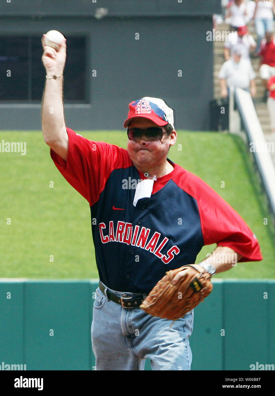 Sgt. John Brough, a 28-year veteran police officer from Belleville, Ill.,  stands with St. Louis Cardinals mascot Fredbird before throwing out the  first pitch in the game against the Washington Nationals Sunday