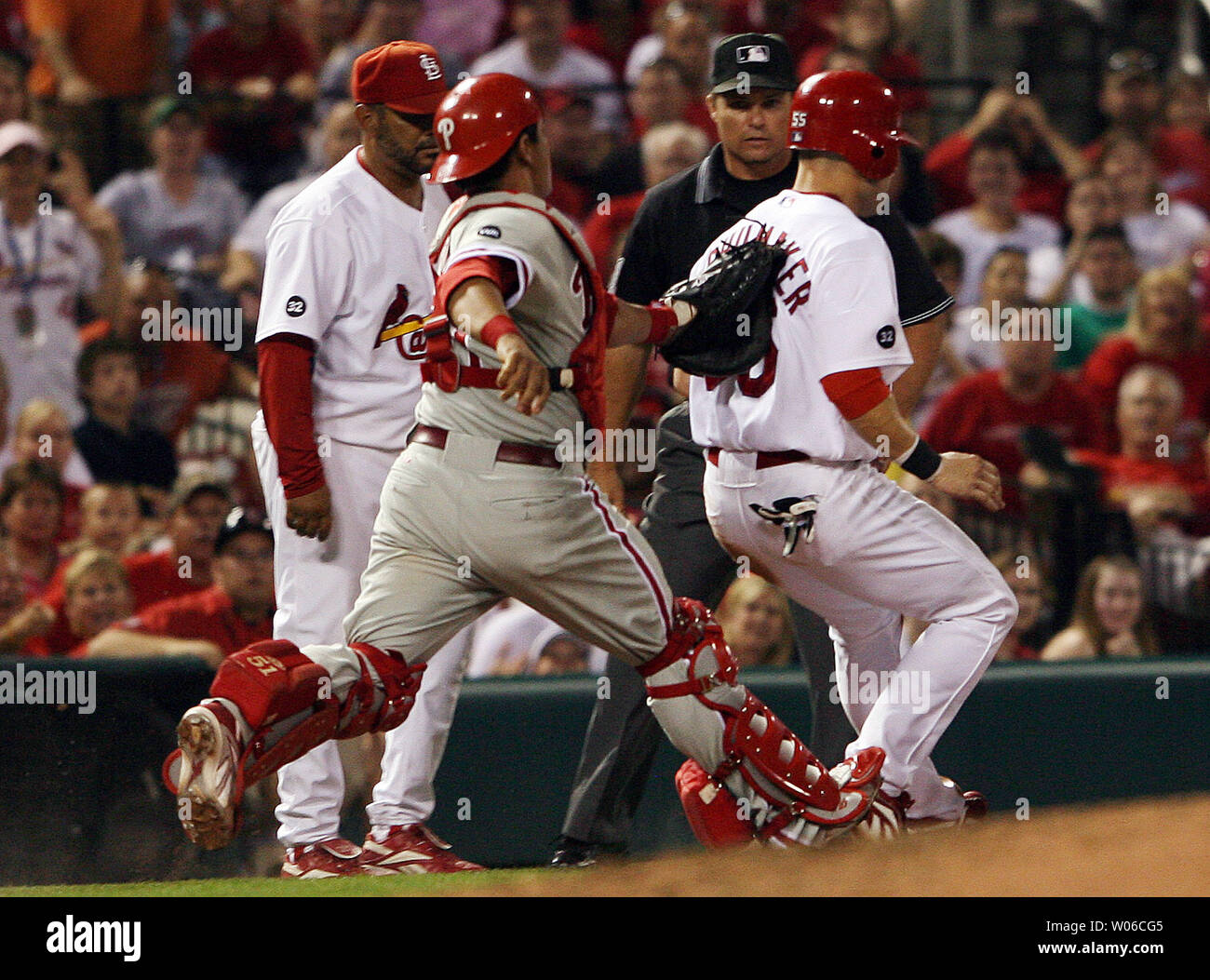 Philadelphia Phillies catcher Carlos Ruiz (L) tags out Cardinals