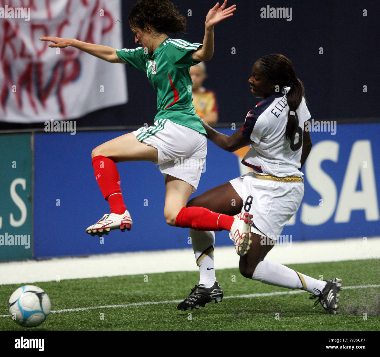 Mexico's women's soccer team member Tania Morales (L) tries to jump
