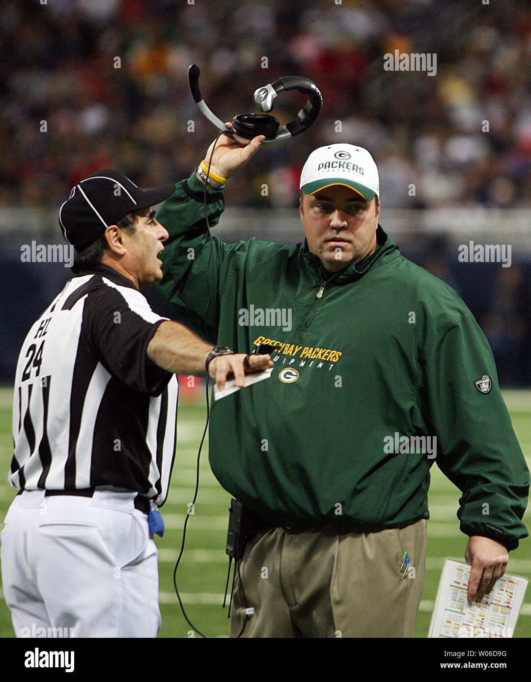 Green Bay Packers head football coach Mike McCarthy (R) gets an explanation  of a call from head linesman Tom Stabile during the second quarter in a  game against the St. Louis Rams (