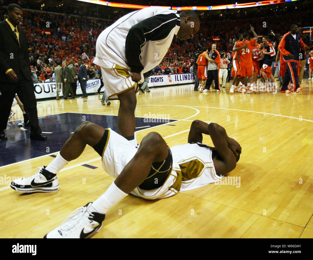 University of Missouri's Michael Anderson Jr. (L) checks on teammate Keon  Lawrence as the University of Illinois celebrate their win 59-58 in the  Annual Busch Braggin' Rights game at the Scottrade Center
