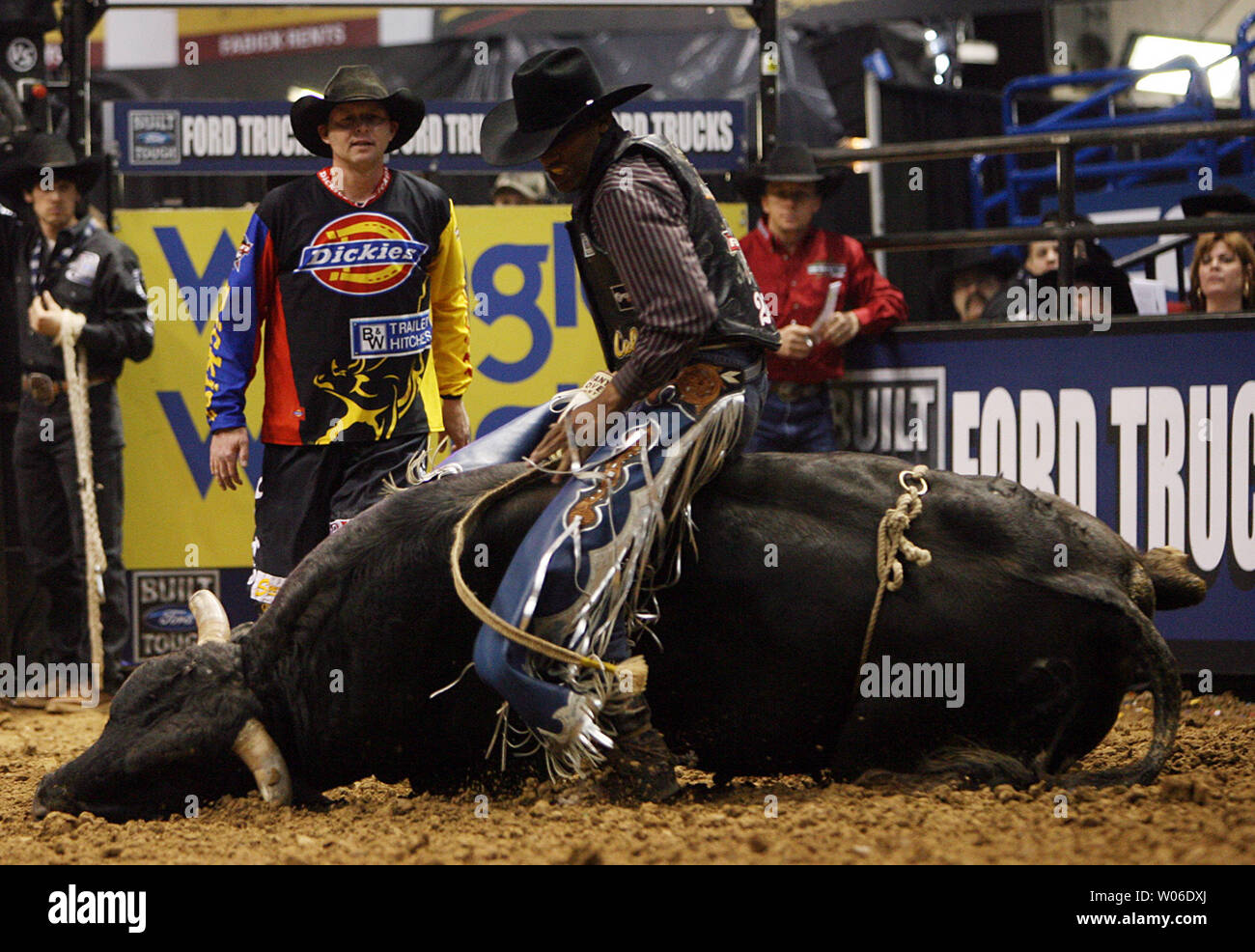 Bull rider Valdiron de Oliveira of Brazil stays on Bravo the bull as it ...