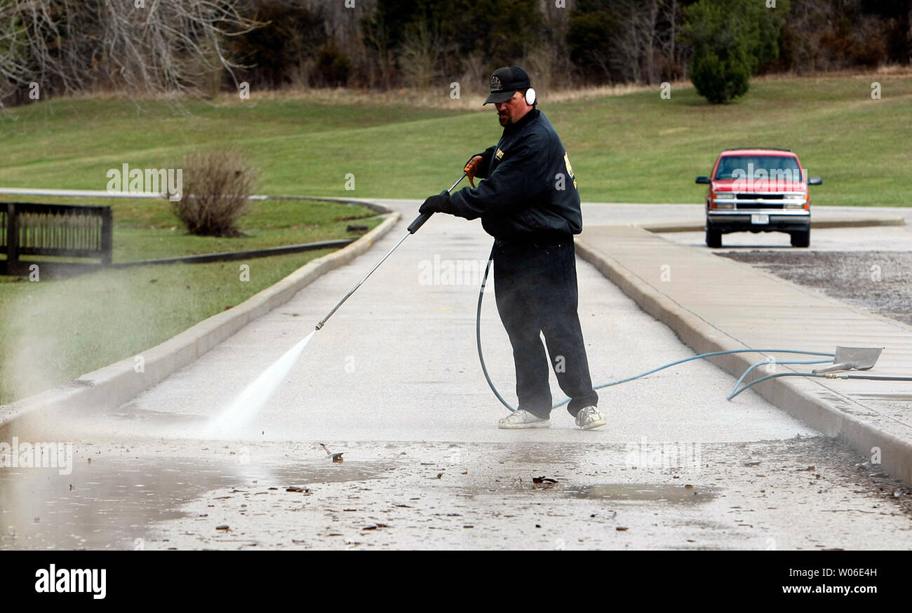 Larry Johnston of Hot Shots Mobil Powerwashing clears the parking 