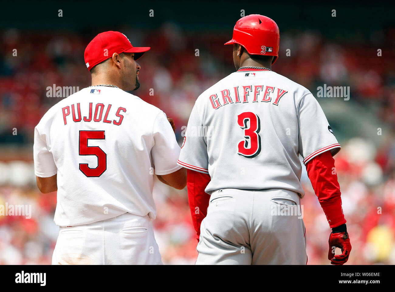 Future National Baseball Hall of Fame members St. Louis Cardinals Albert  Pujols (L) and Cincinnati Reds Ken Griffey Jr. talk after Griffey reached  first base on an infield single in the seventh