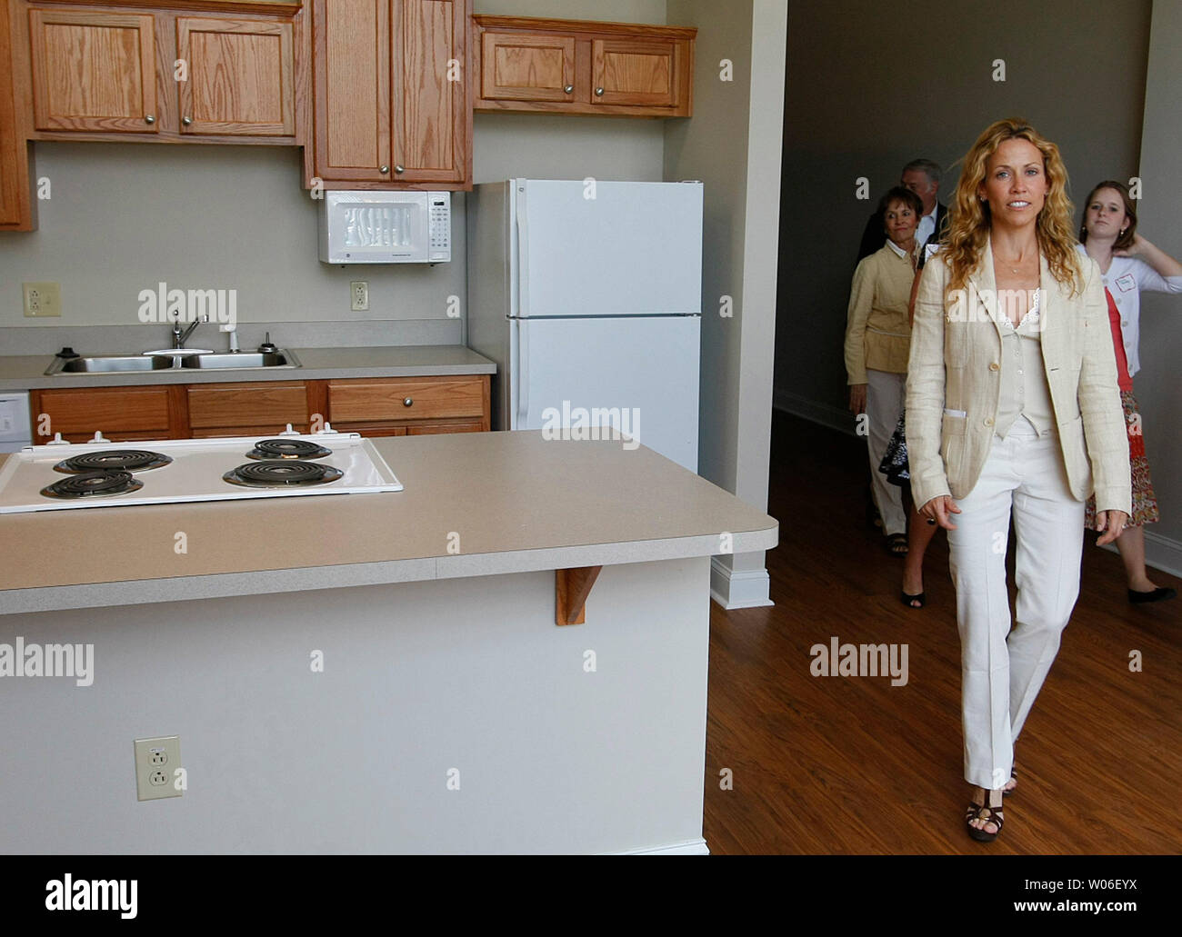 Singer Sheryl Crow enters an apartment at the old Ely and Walker Shirt