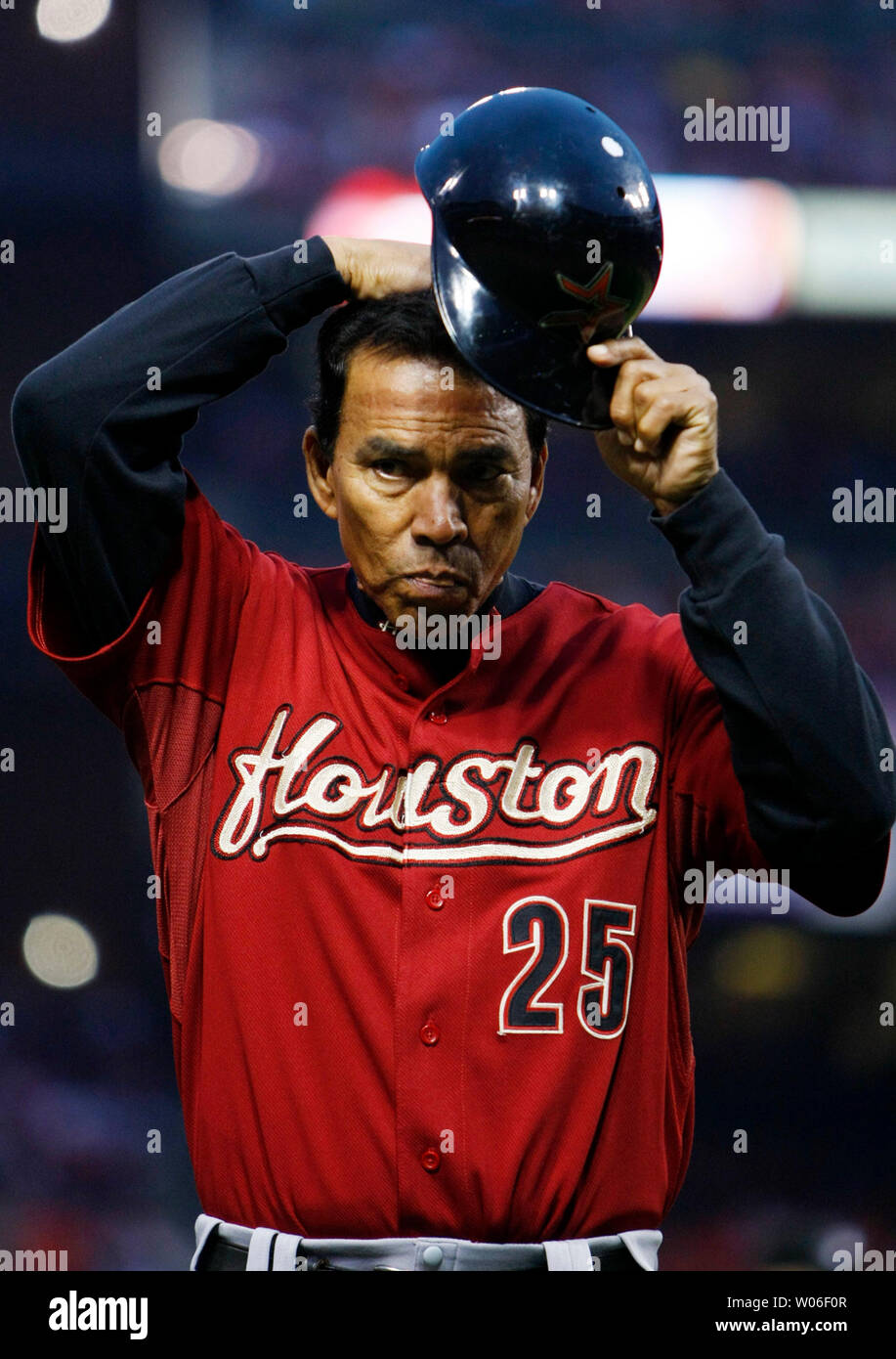 Houston Astros first base coach Jose Cruz checks his hair as he comes off  the field in the third inning against the St. Louis Cardinals at Busch  Stadium in St. Louis on