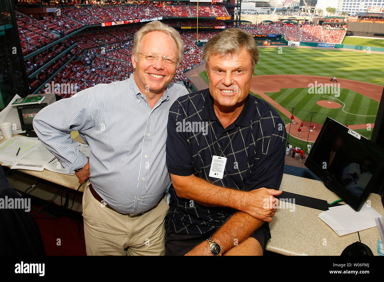 ESPN Radio announcers Gary Thorne (L) and Dave Campbell, pose for a photograph in their booth before the Philadelphia Phillies