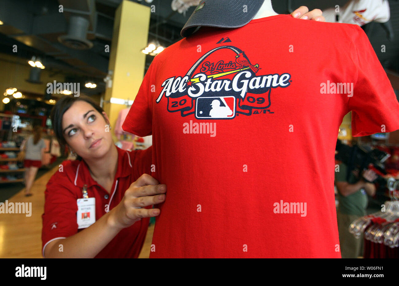 Megan Curts, a supervisor in the St. Louis Cardinals team store at Busch  Stadium, adjusts a new All-Star tee-shirt on a mannequin in St. Louis on  August 5, 2008. The 2009 All-Star