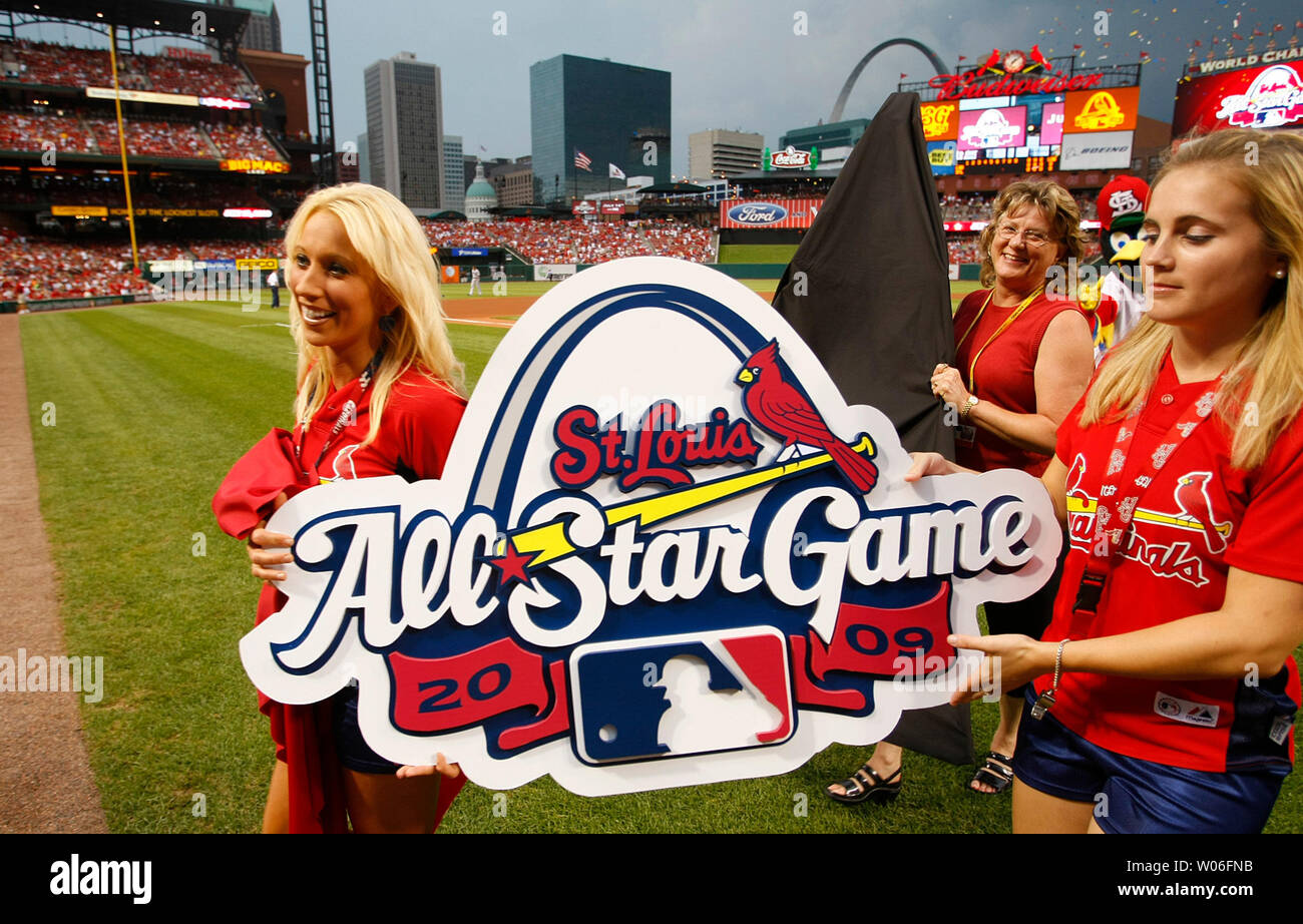Fredbird Team girls carry the All-Star logo for the 2009 All-Star Game off  the field after a ceremony before the Los Angeles Dodgers St. Louis  Cardinals baseball game at Busch Stadium in