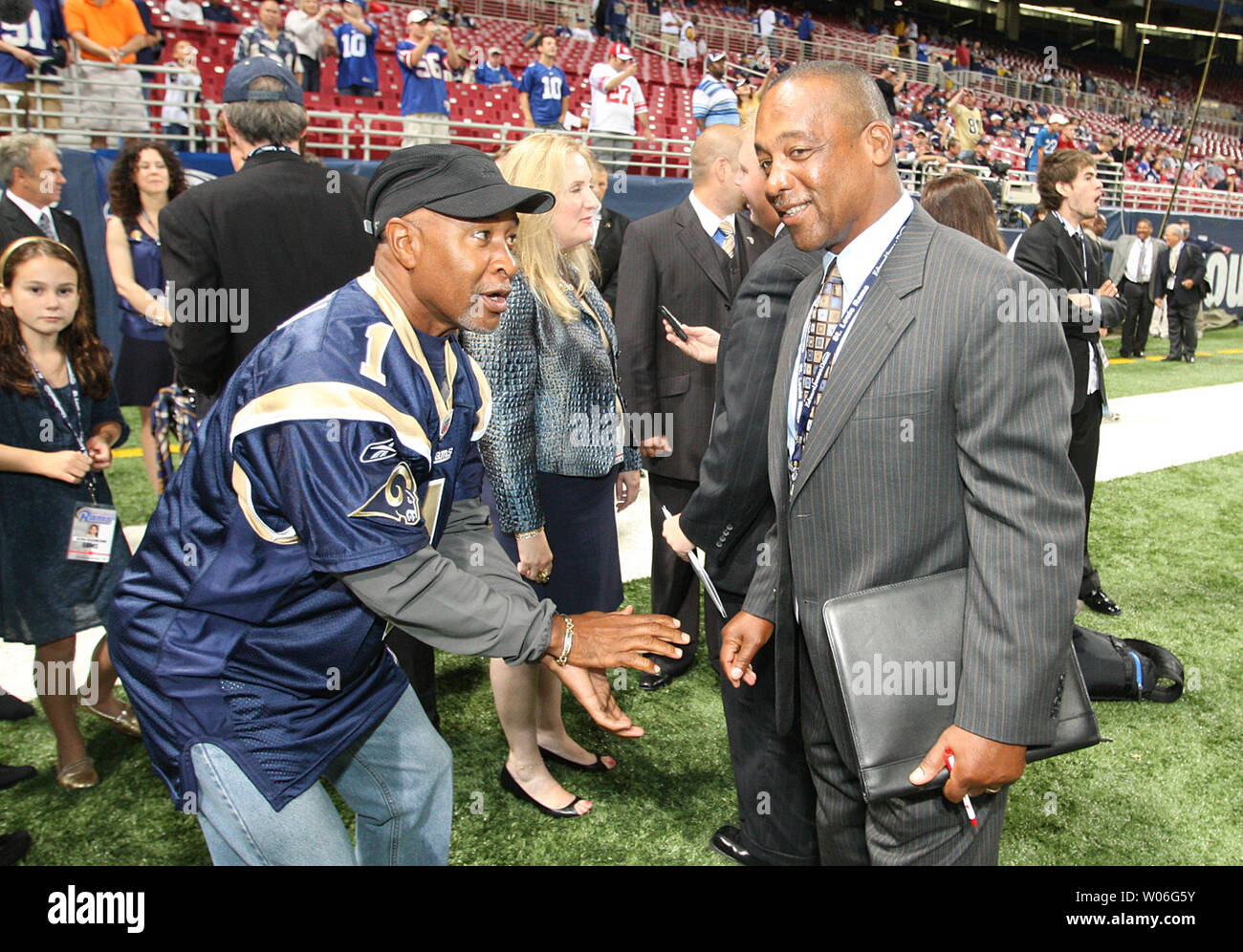 National Baseball Hall of Fame member Ozzie Smith (L) shows former St. Louis Football Cardinals running back Willard Harrell how to take a snap before the St. Louis Rams - New York Giants football game at the Edward Jones Dome in St. Louis on September 12, 2008. New York won the game 41-13.  (UPI Photo/Bill Greenblatt) Stock Photo