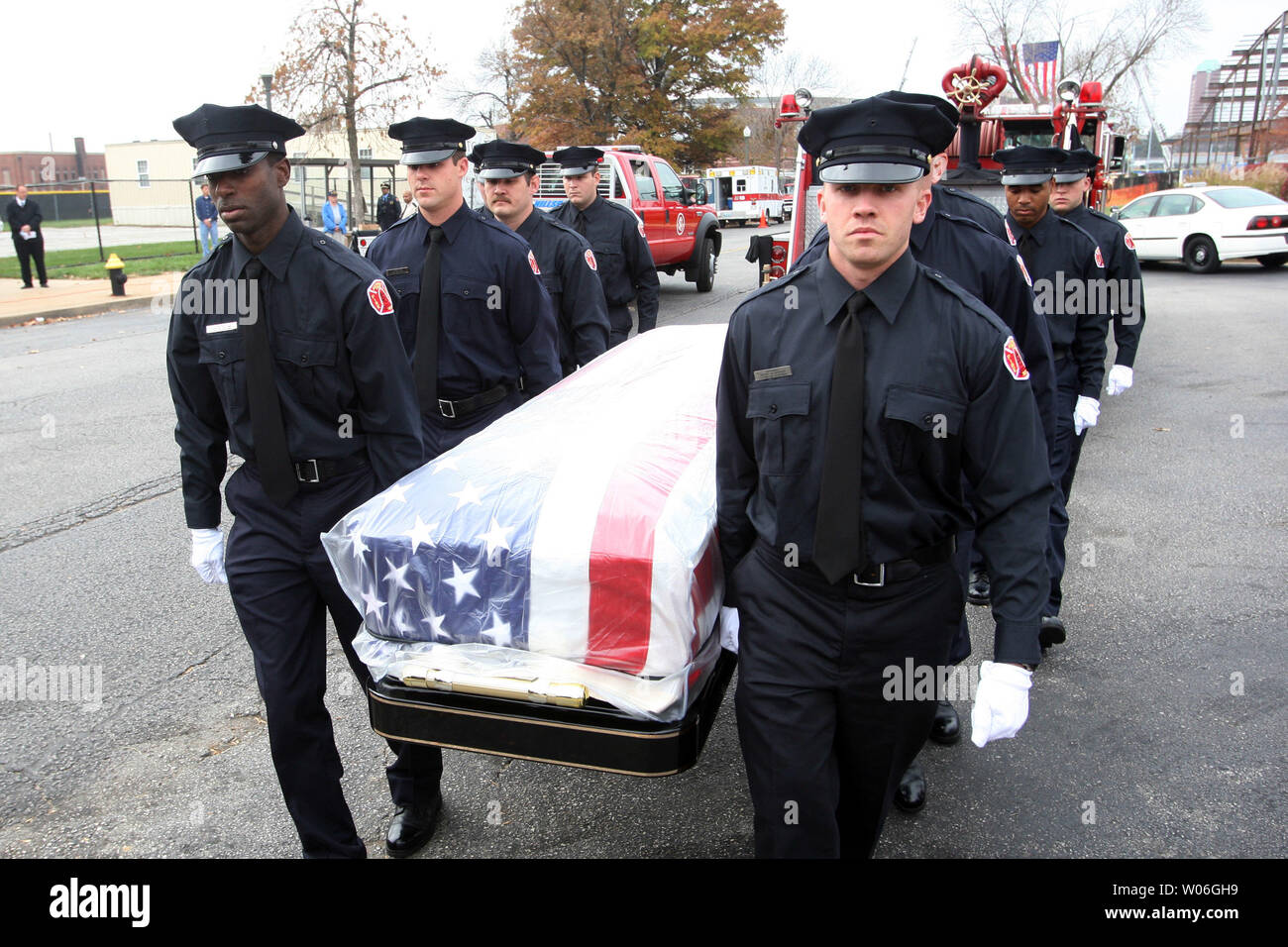 Members of the St. Louis Fire Department carry the casket of slain