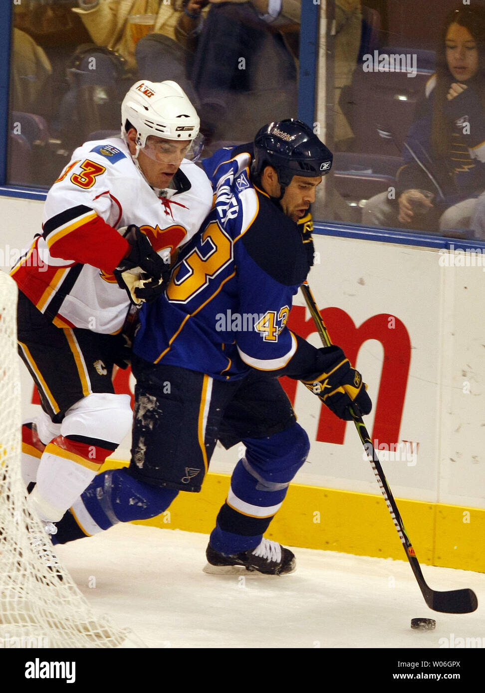 Calgary Flames Michael Cammalleri (L) applies pressure to St. Louis Blues Mike Weaver near the St. Louis net in the first period at the Scottrade Center in St. Louis on December 16, 2008. Calgary won the game 6-2.  (UPI Photo/Bill Greenblatt) Stock Photo
