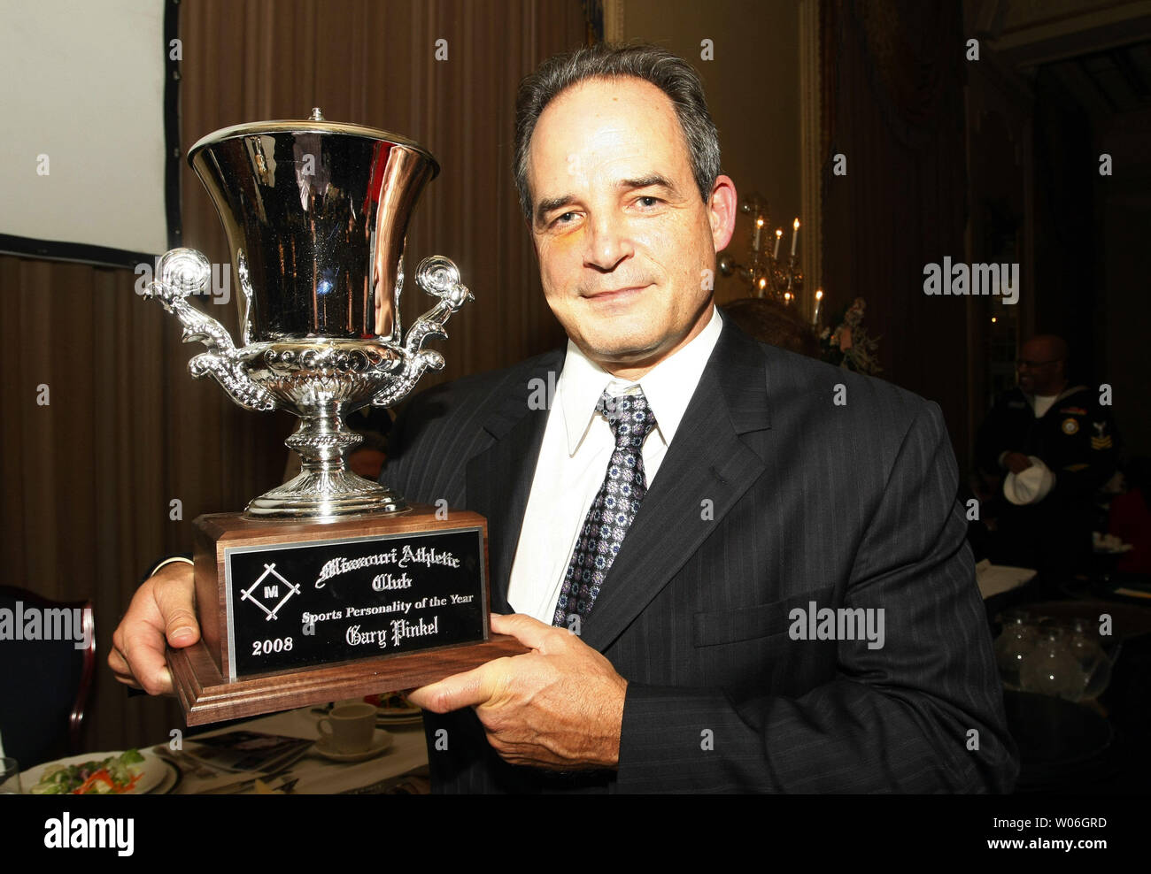 University of Missouri head football coach Gary Pinkel holds the trophy ...