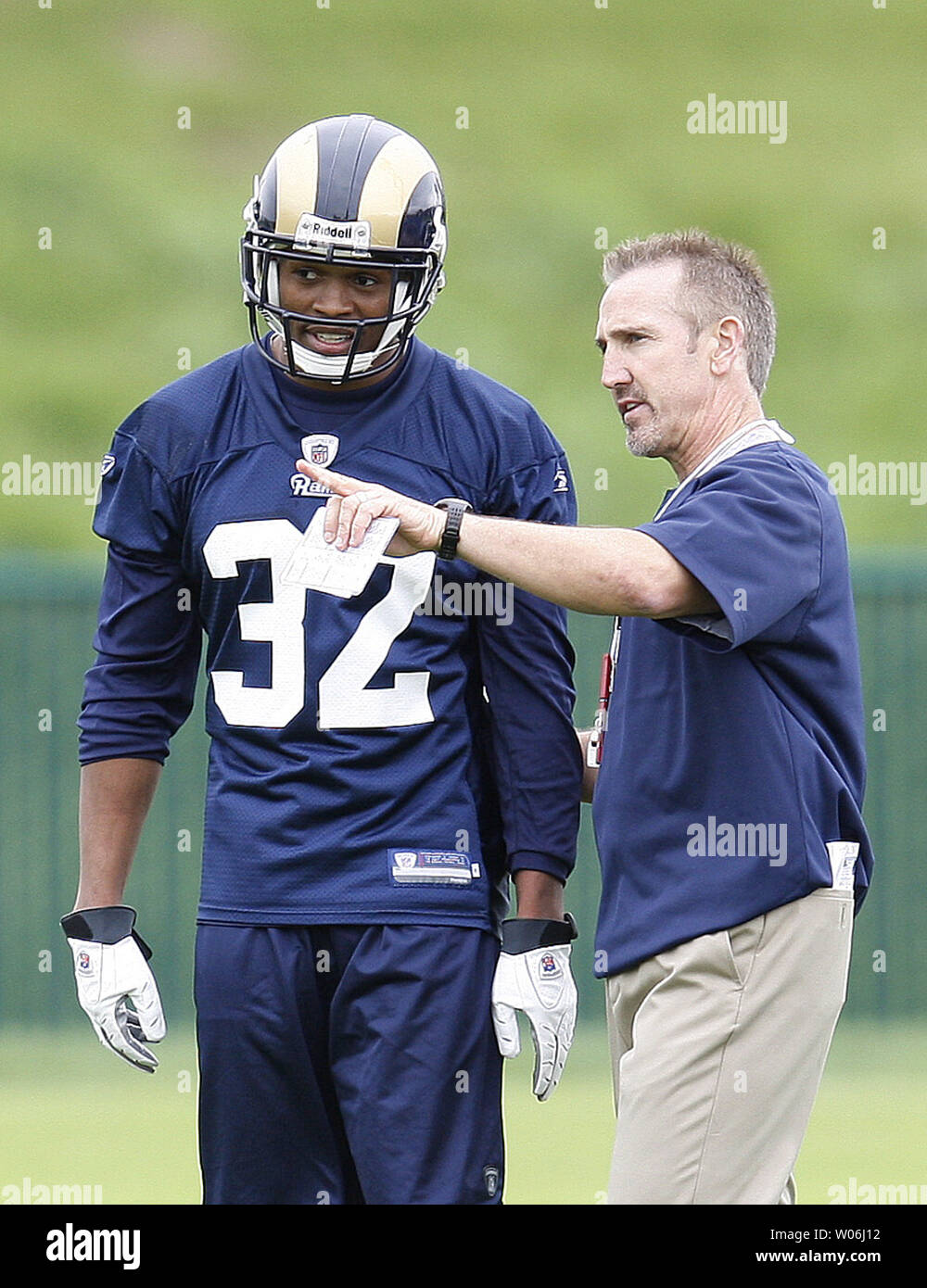 St. Louis Rams head football coach Steve Spagnuolo gives instructions to  rookie Bradley Fletcher on the first day of mini camp at the team's  practice facility in Earth City, Missouri on May