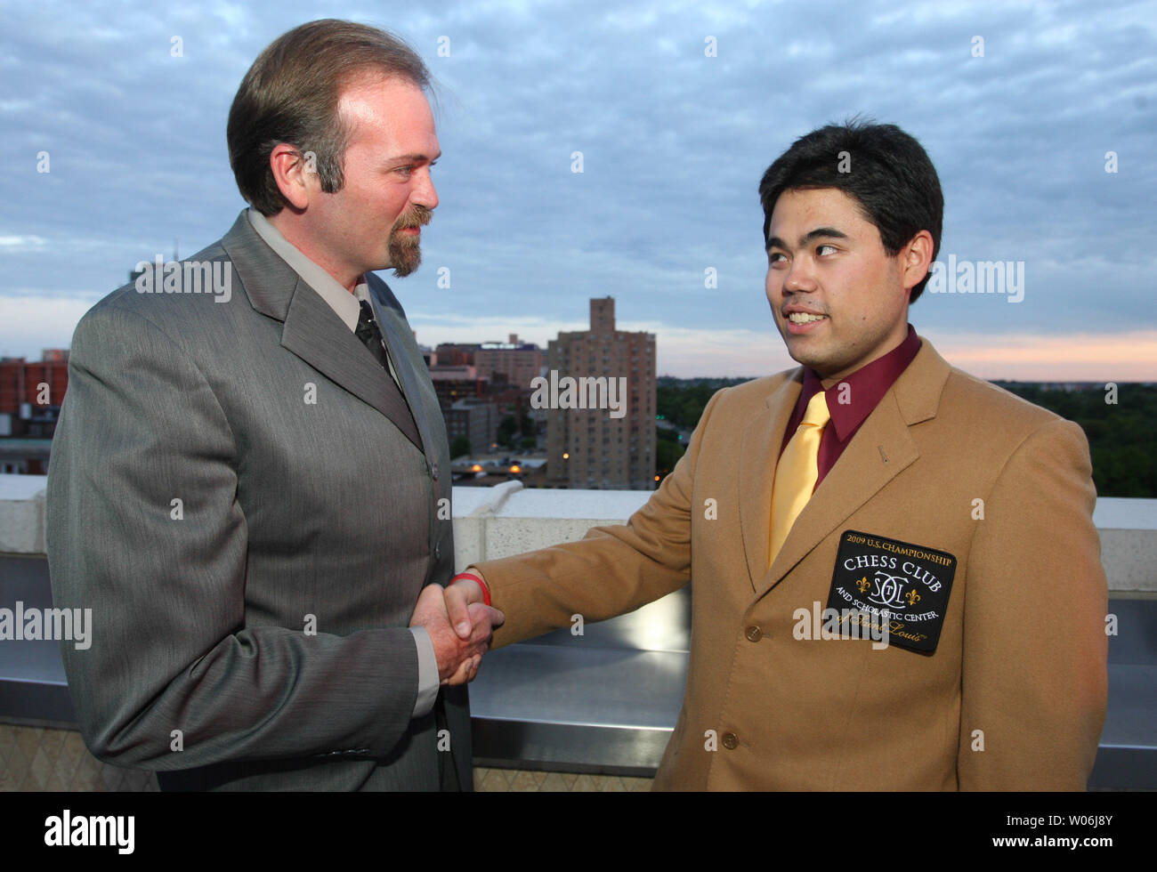 Hikaru Nakamura of White Plains, New York (R) is congratulated by Bill Hall, executive director of the U.S. Chess Federation after winning the Brown Jacket and the U.S. Chess Championship in St. Louis on May 17, 2009. Nakamura beat out 25 others from across the United States to win the invitational tournament. (UPI Photo/Bill Greenblatt) Stock Photo