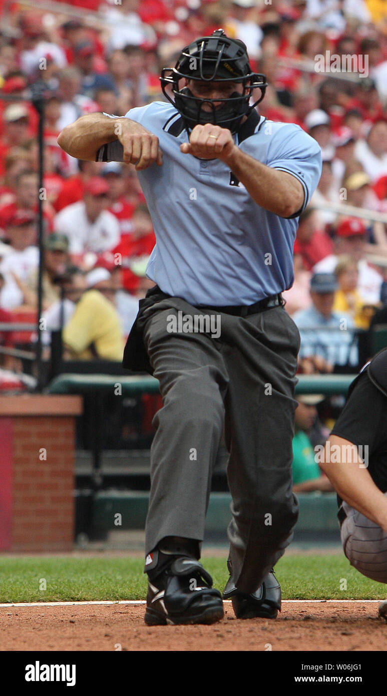 Homeplate umpire Angel Hernandez signals a strikeout during the Colorado RockiesSt. Louis