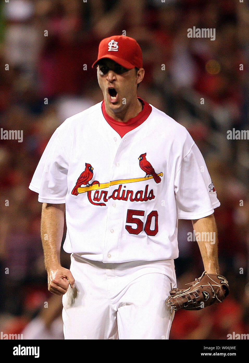 St. Louis Cardinals starting pitcher Adam Wainwright gives out a