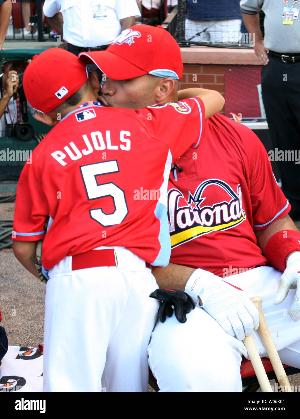 A.J. Pujols (8) gives his dad Albert Pujols a hug before the Home