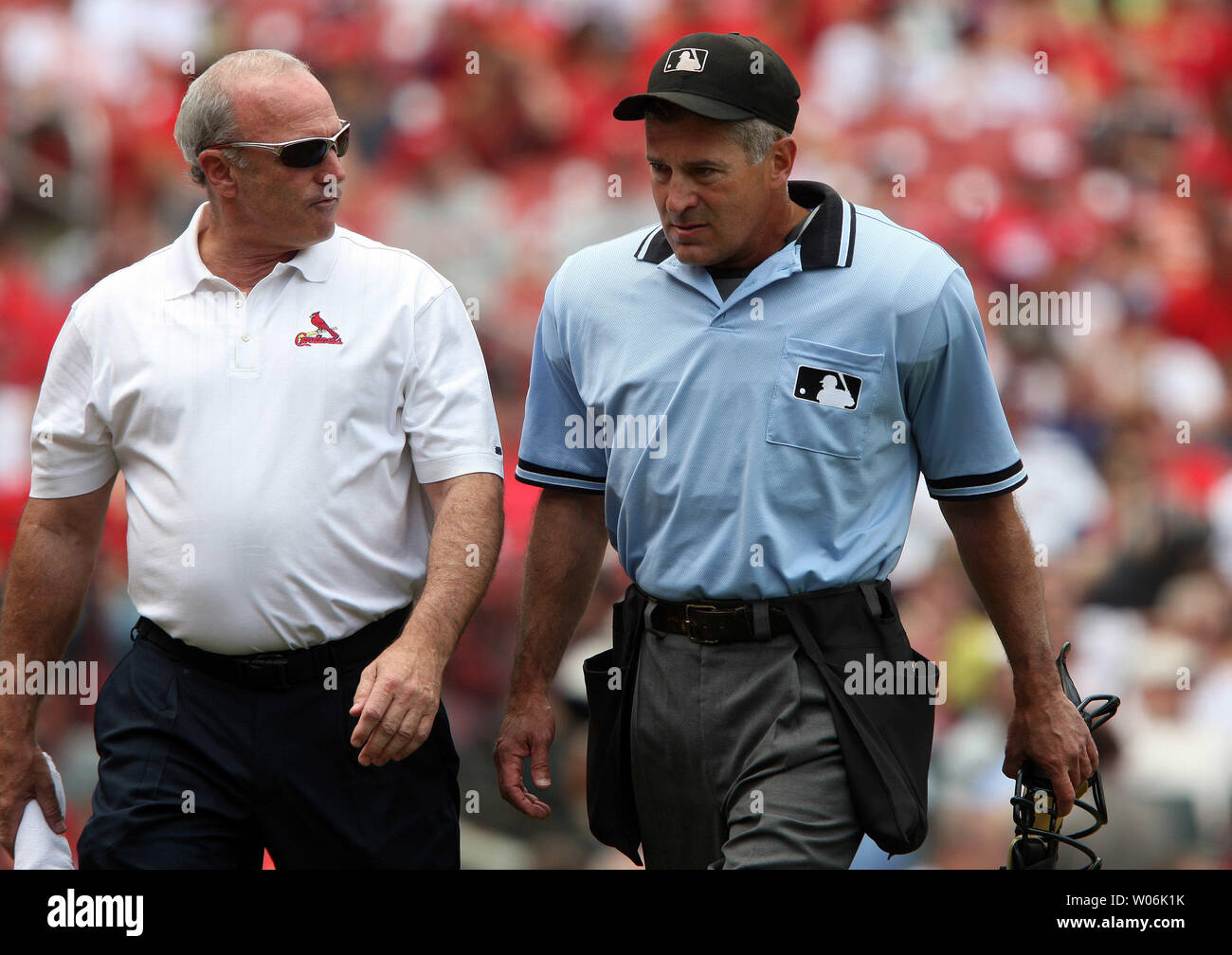 St. Louis Cardinals head trainer Barry Weinberg (L) walks home plate umpire John Hirschbeck off the field after Hirschbeck took a foul tip to the face off Arizona Diamondbacks Justin Upton in the first inning at Busch Stadium in St. Louis on July 19, 2009. Hirshbeck left the game with a mild concussion.    (UPI Photo/Bill Greenblatt) Stock Photo