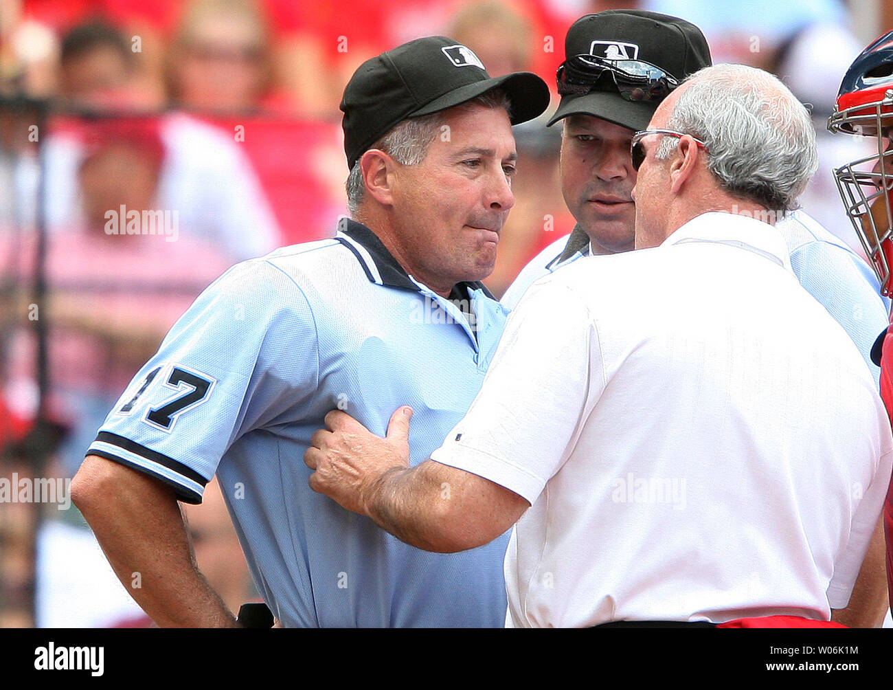 St. Louis Cardinals head trainer Barry Weinberg (R) checks the status of home plate umpire John Hirschbeck after taking a foul tip to the face off Arizona Diamondbacks Justin Upton in the first inning at Busch Stadium in St. Louis on July 19, 2009. Looking on is crew chief Wally Bell. Hirshbeck left the game with a mild concussion.    (UPI Photo/Bill Greenblatt) Stock Photo