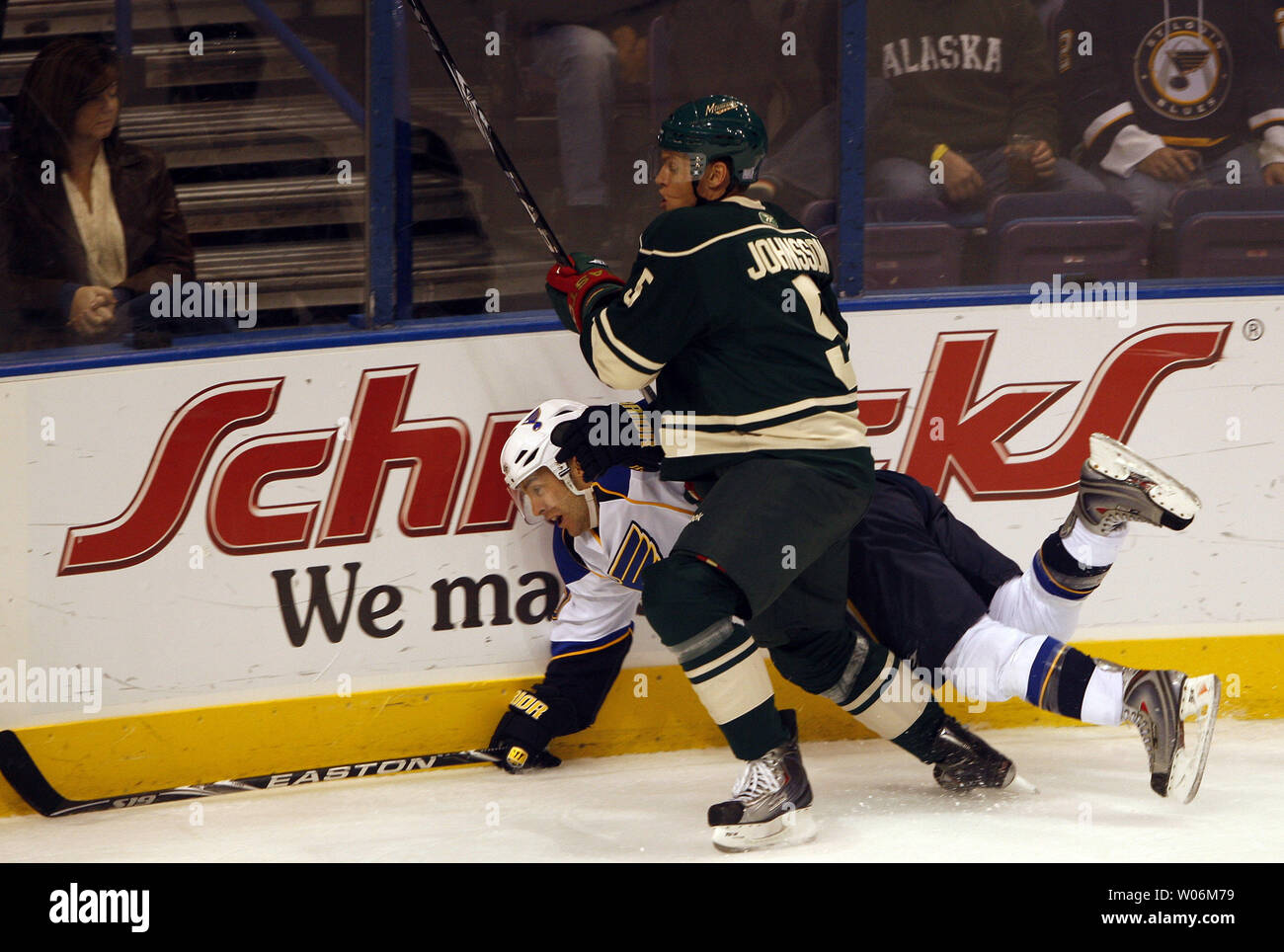 Minnesota Wild Kim Johnsson (5) takes down St. Louis Blues Andy McDonald during the first period at the Scottrade Center in St. Louis on October 23, 2009. UPI/Bill Greenblatt Stock Photo