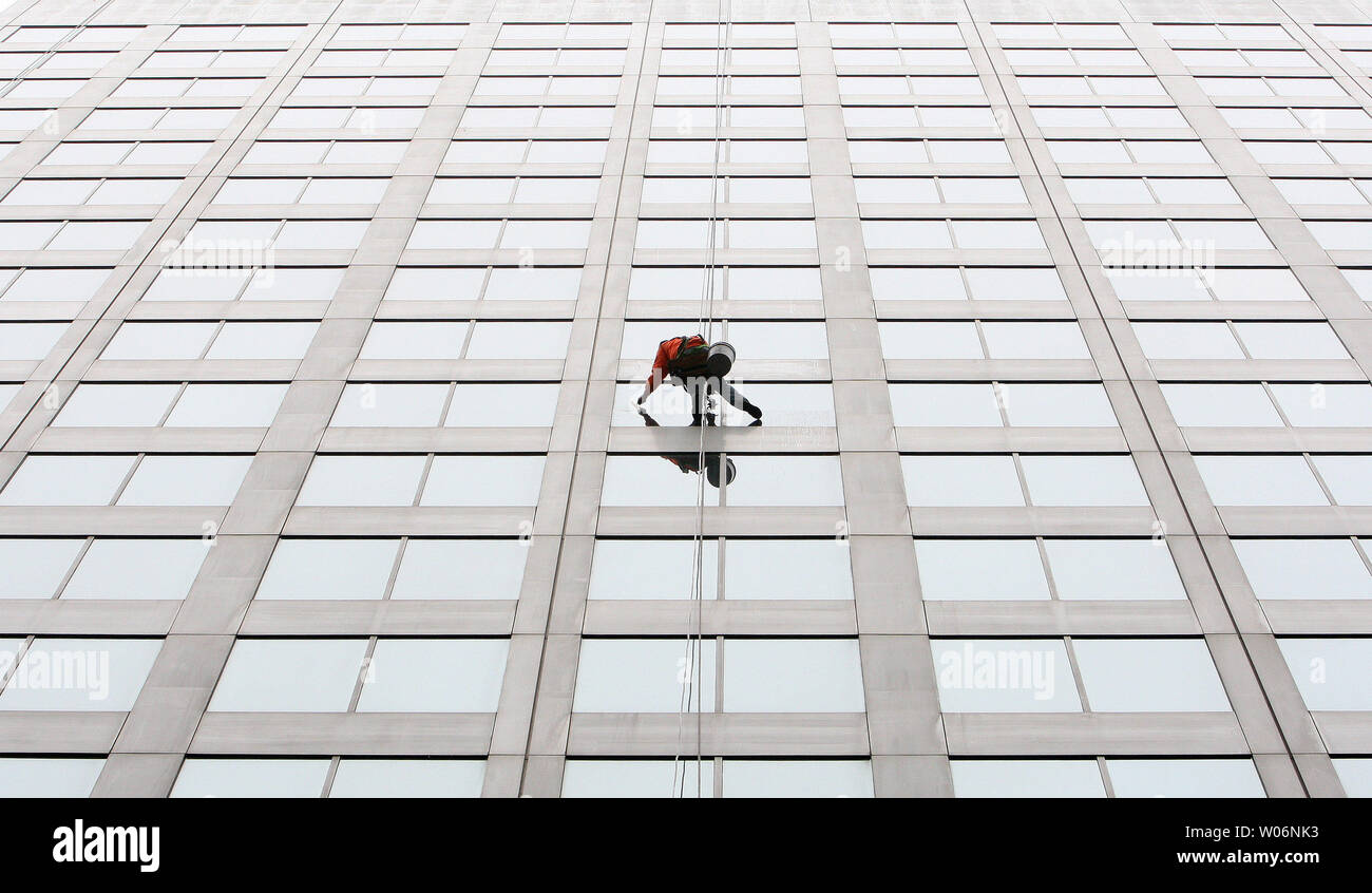 A window washer dangles from the 13th floor as he washes the windows on the Bank of America Building in downtown St. Louis on January 18, 2010.    UPI/Bill Greenblatt Stock Photo